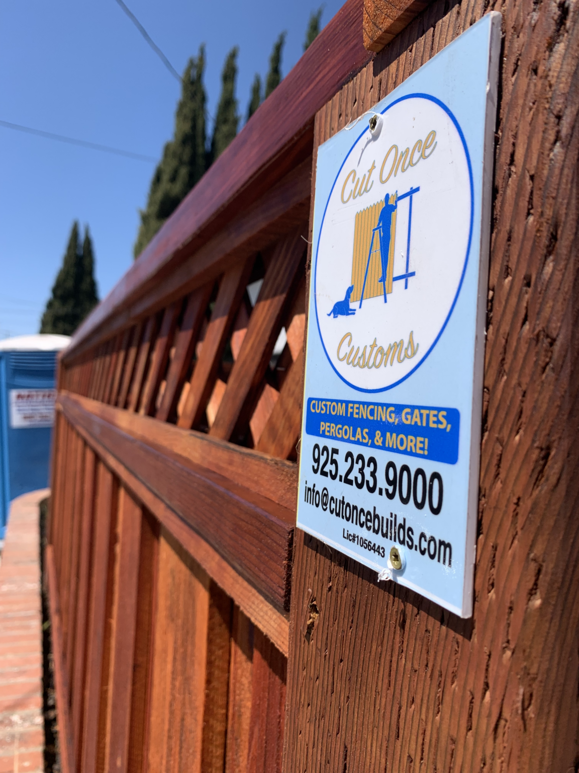 Cut Once Construction project sign attached to a redwood fence project.