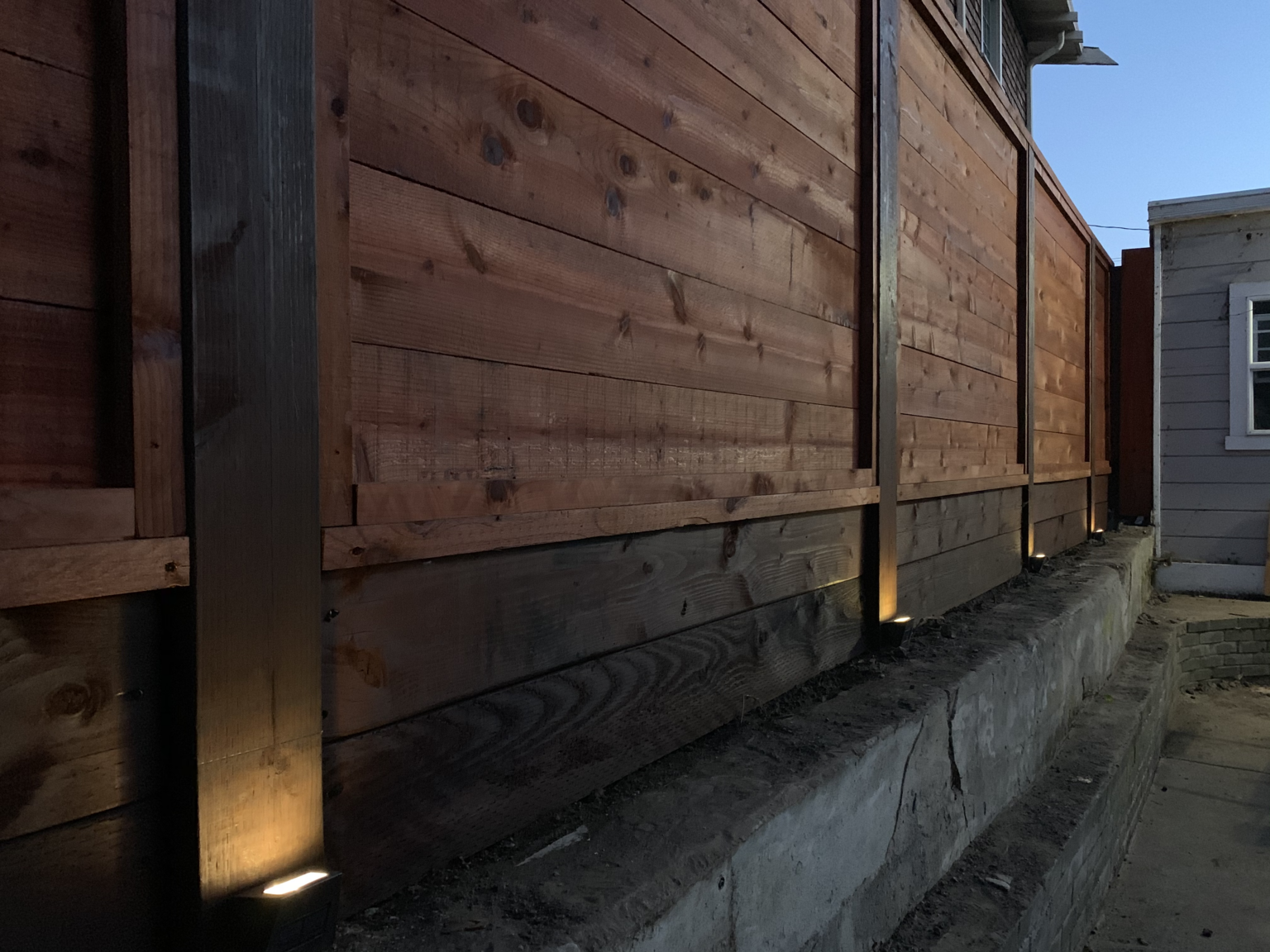 Horizontal redwood privacy fence with matching side gate built in Oakland, CA.